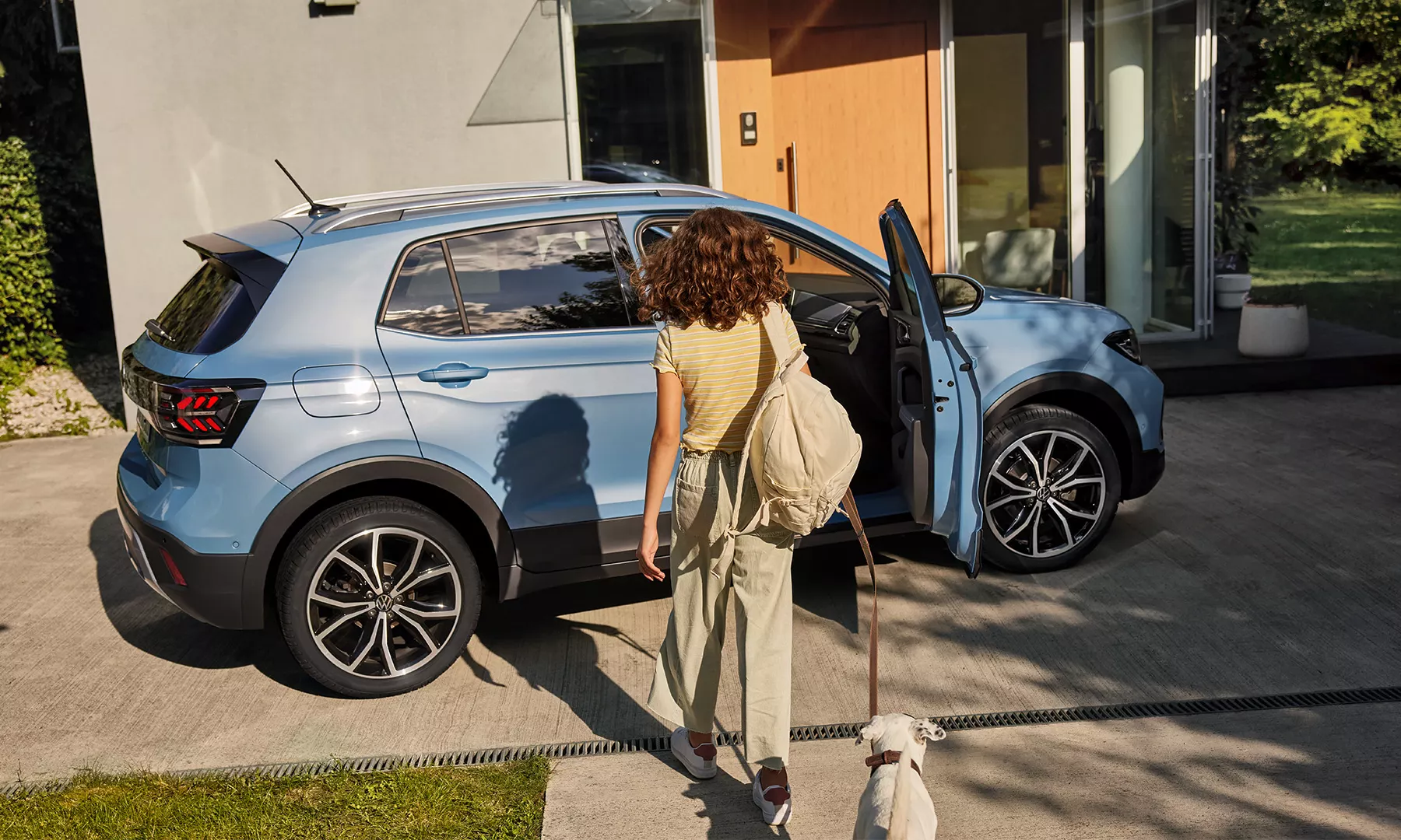 TS0664_t-cross_exterior-woman-infront-of-yellow-t-cross-with-open-passenger-door